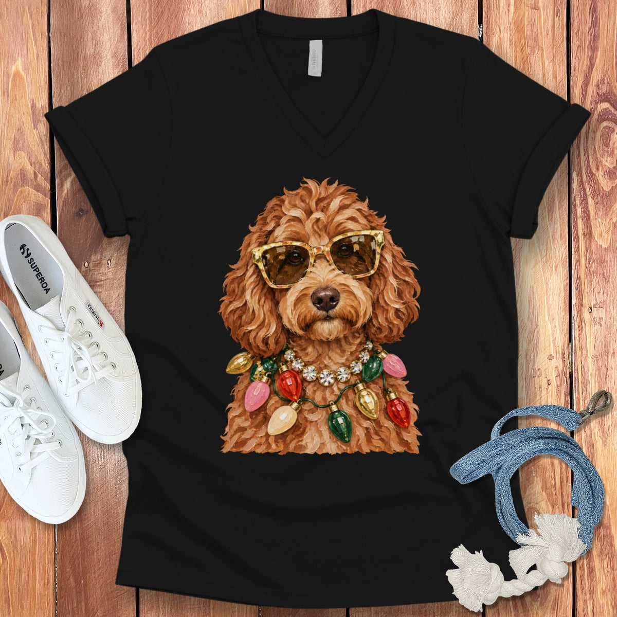 Black t-shirt with a drawing of a fluffy dog wearing sunglasses and a string of Christmas lights.