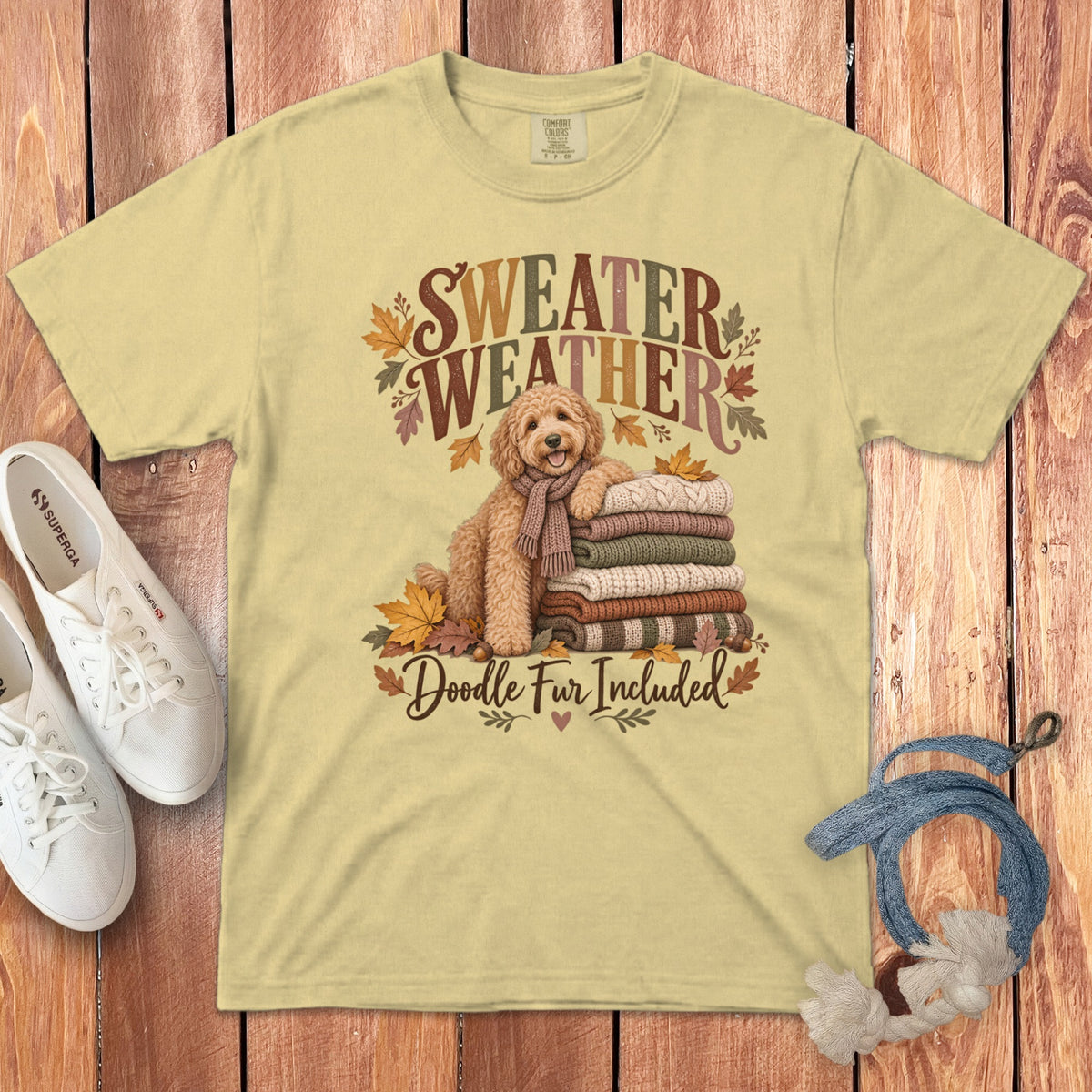 Light yellow t-shirt with "Sweater Weather Doodle Fur Included" text and an autumn doodle.