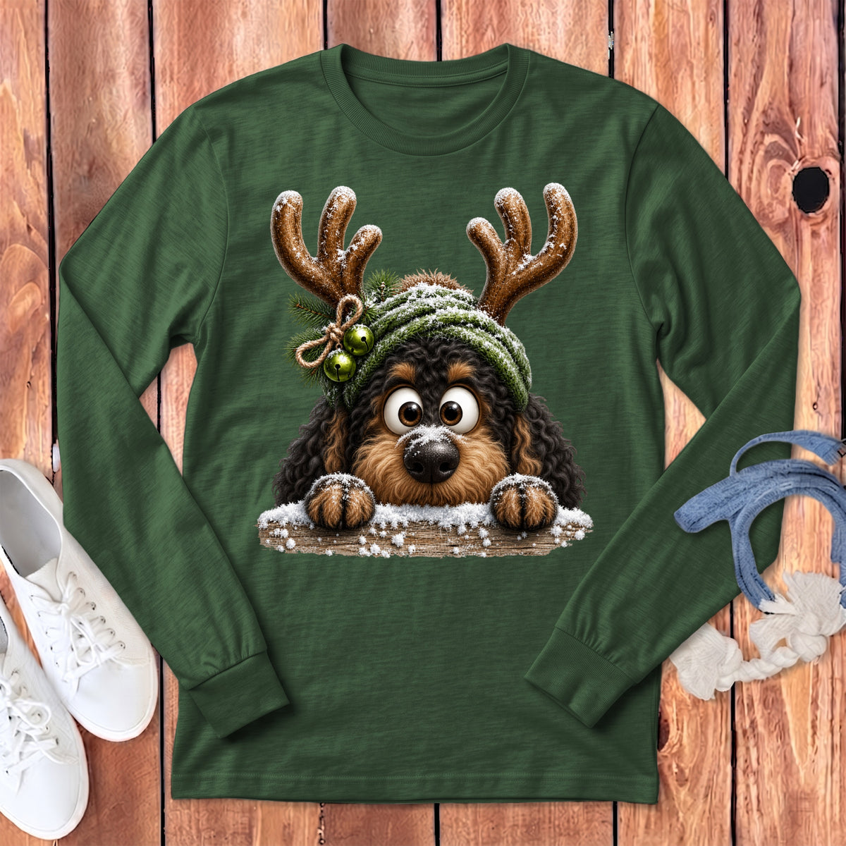 Green long-sleeve t-shirt with a cute dog wearing reindeer antlers and a knitted hat.