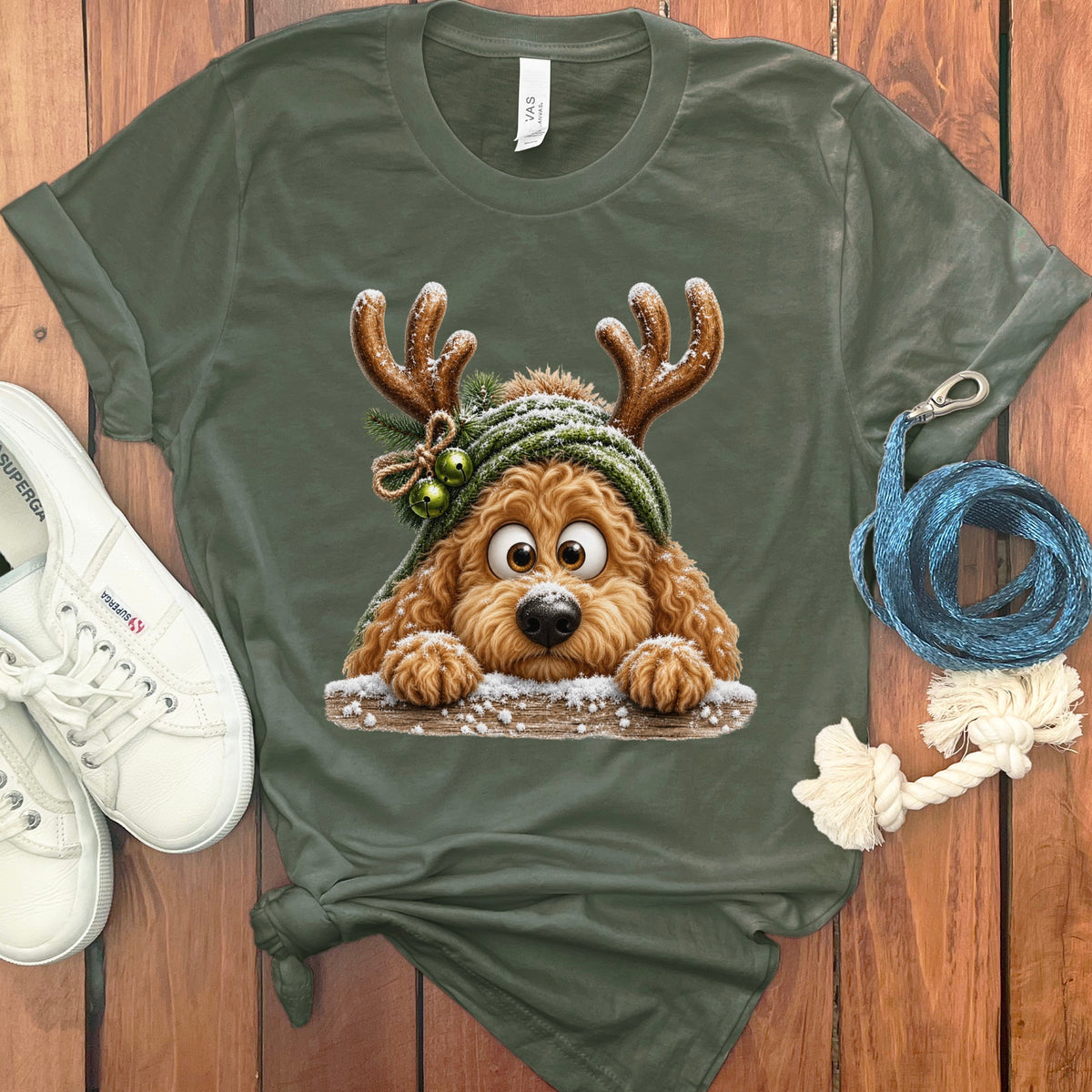Green t-shirt with cartoon dog wearing antlers and a green beanie.