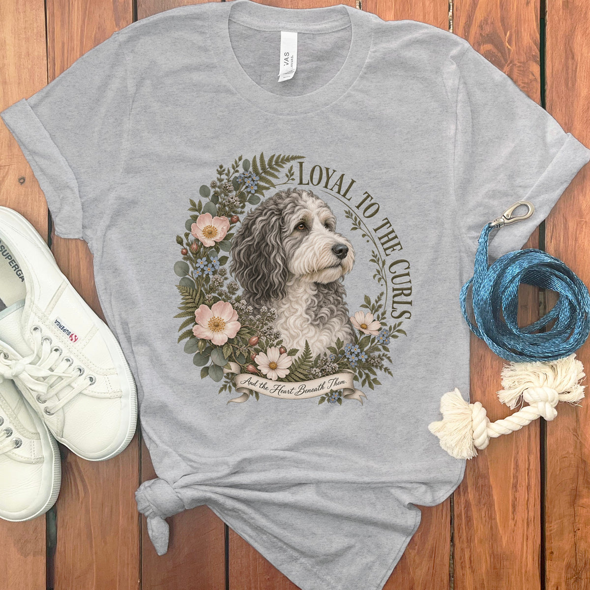 Gray t-shirt with a floral wreath design featuring a dog and text.
