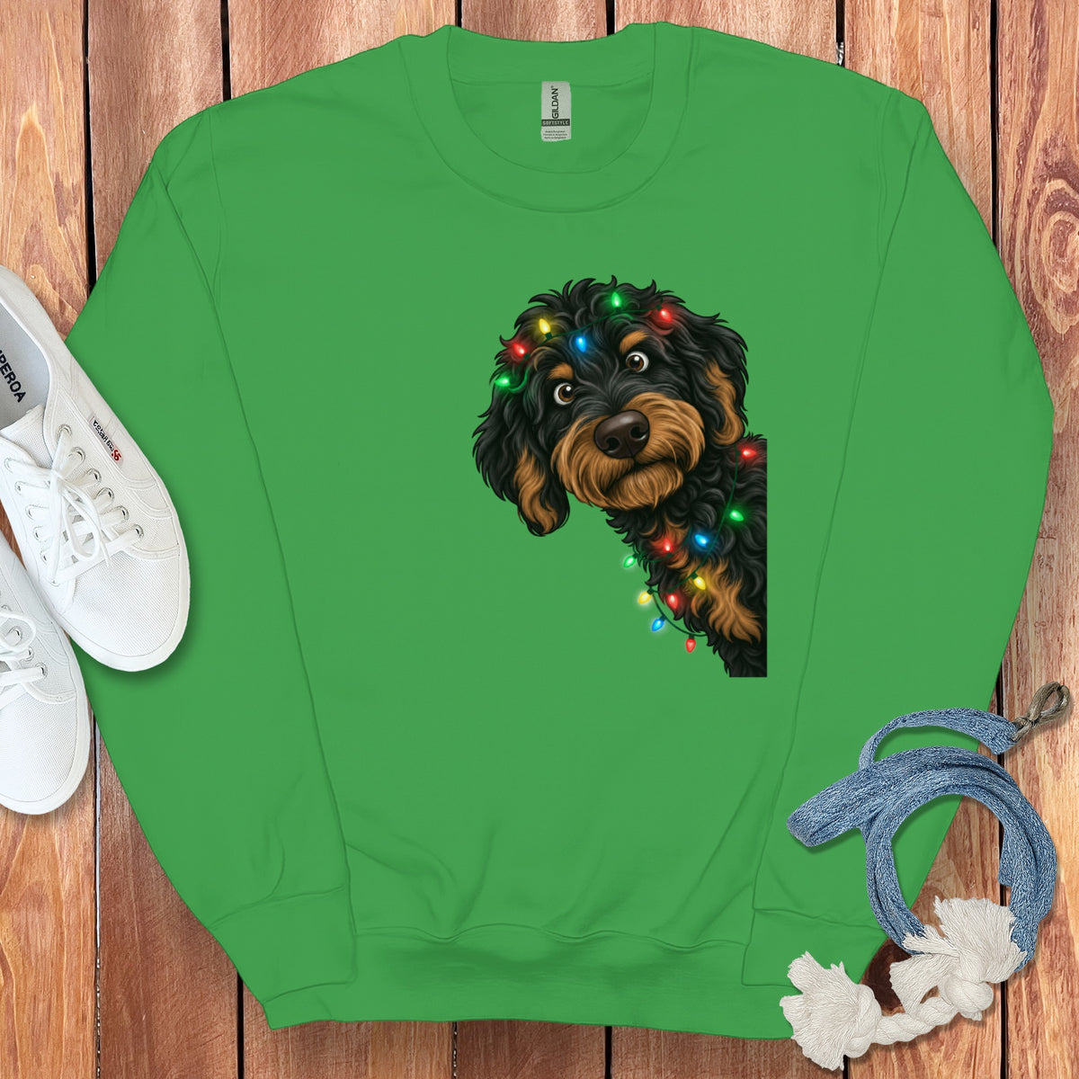 Green sweatshirt with a dog adorned with colorful Christmas lights.