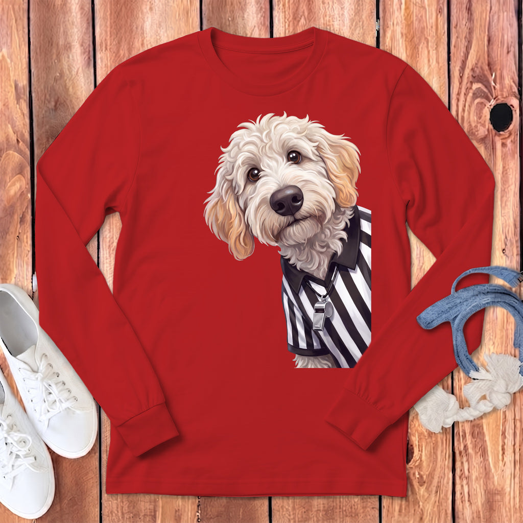 Goldendoodle dog wearing a referee shirt with a whistle on a red long-sleeve shirt.