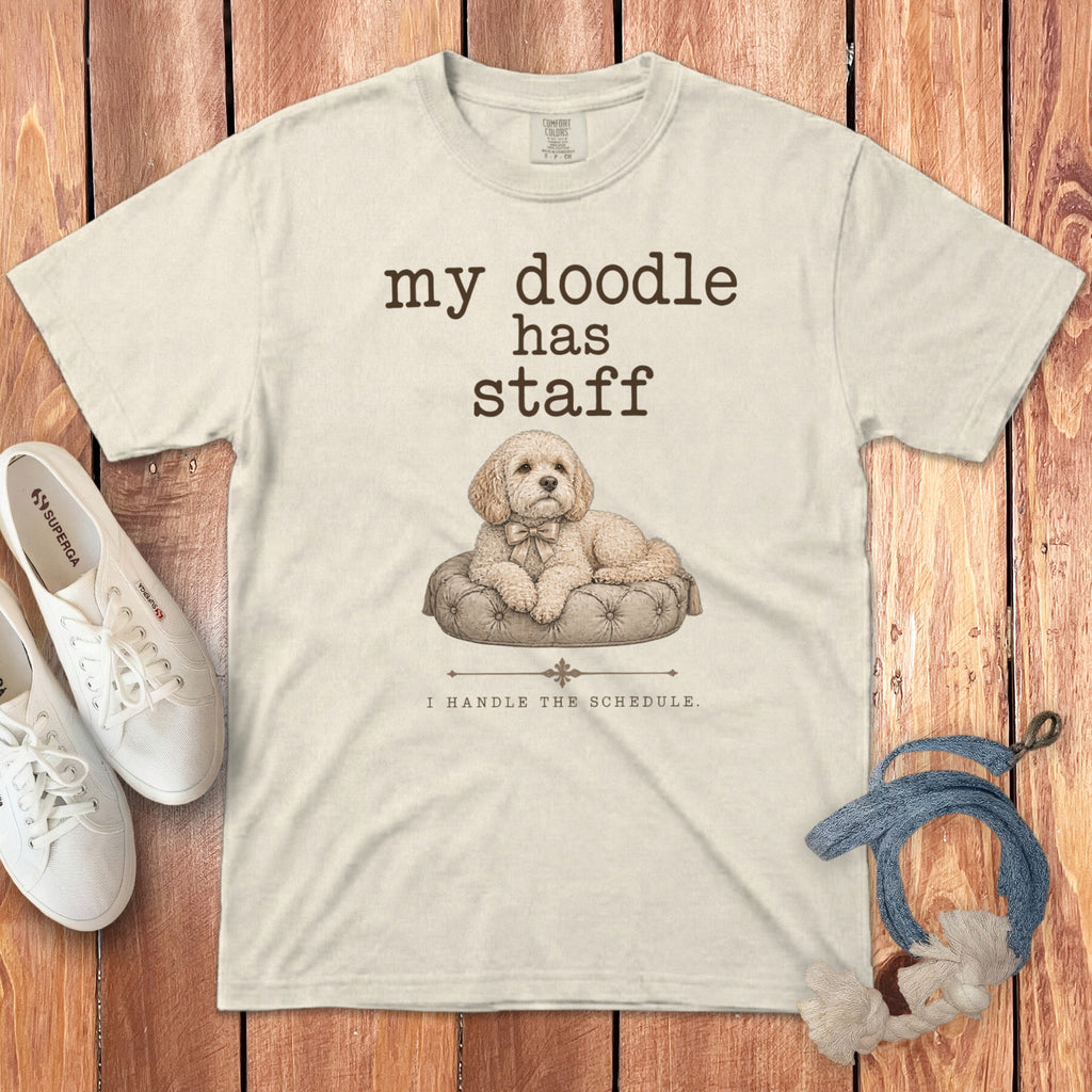 Cream t-shirt with a doodle dog graphic and text "my doodle has staff I HANDLE THE SCHEDULE."