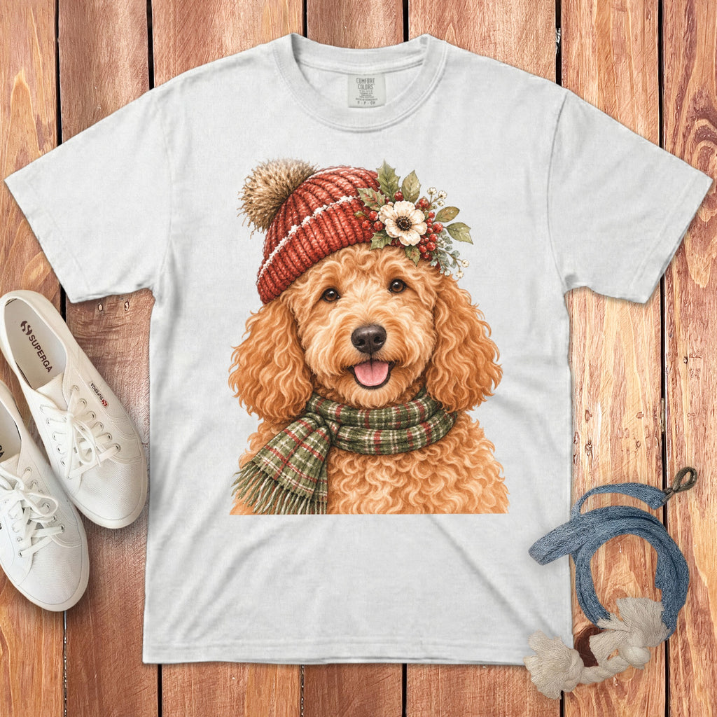 White t-shirt with a watercolor painting of a golden doodle wearing a red knit hat and scarf.