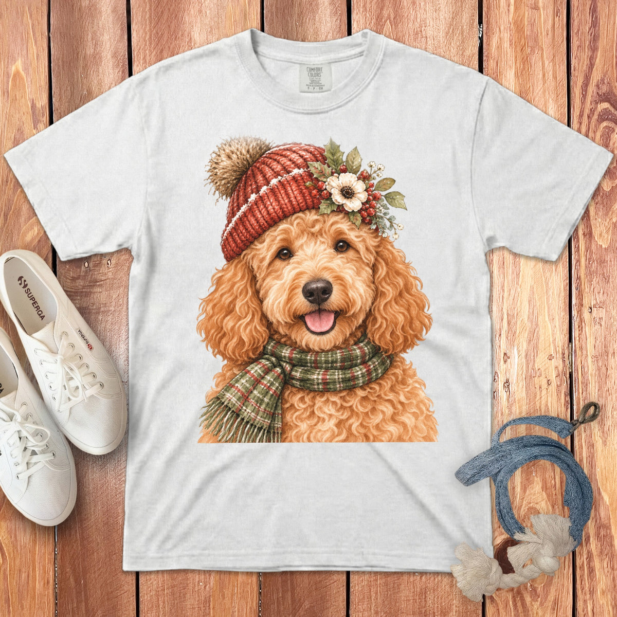 White t-shirt with a watercolor painting of a golden doodle wearing a red knit hat and scarf.