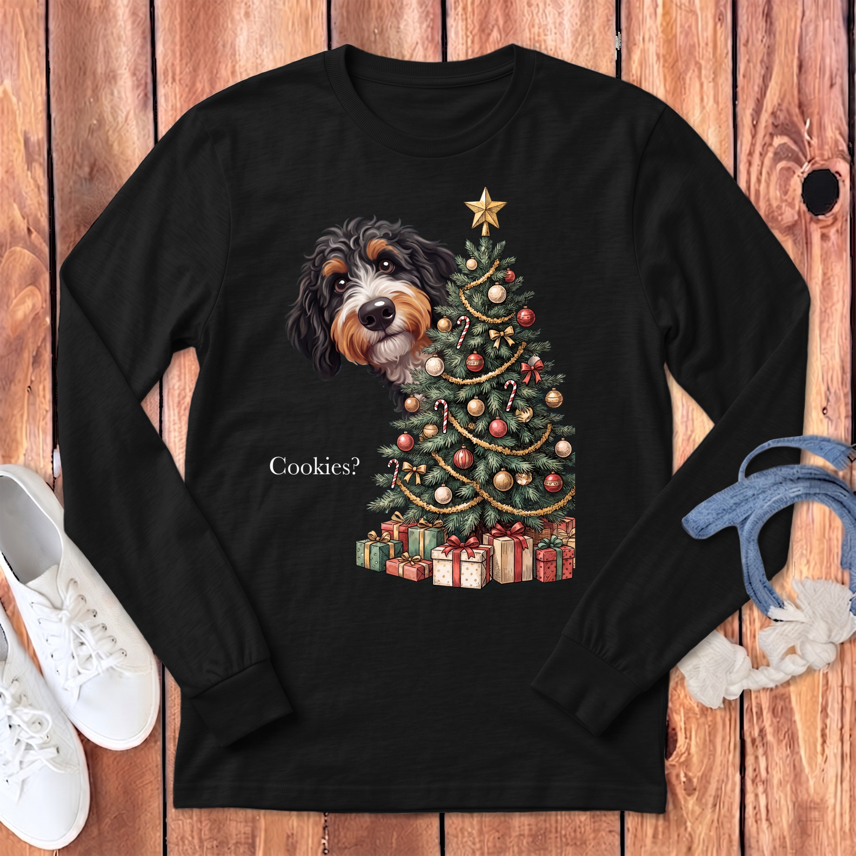 Bernese Mountain Dog peeking from behind a decorated Christmas tree with gifts and text "Cookies?".