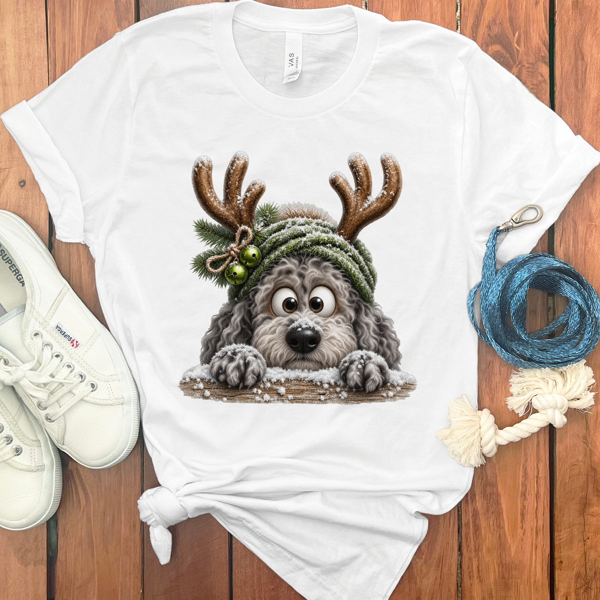 White t-shirt with a cartoon dog wearing antlers and a beanie.