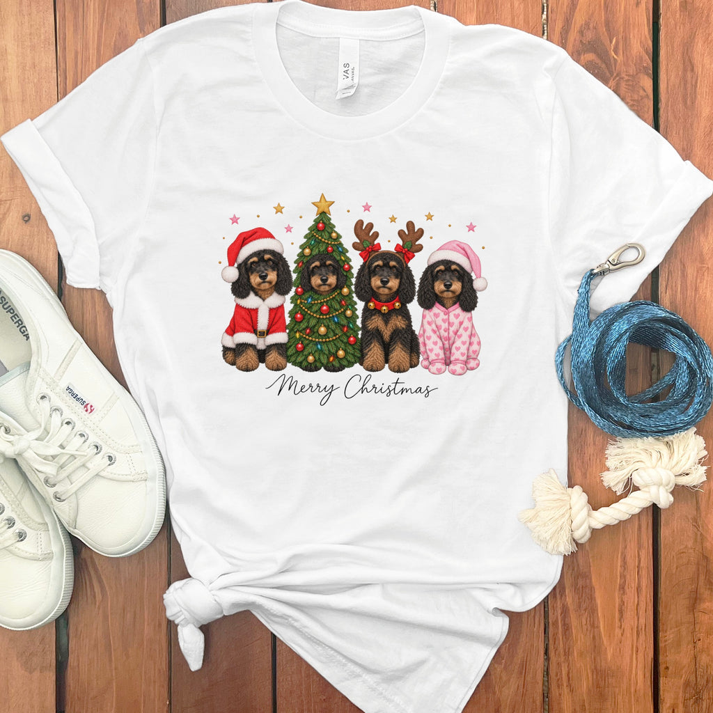 White t-shirt featuring a graphic of four dogs dressed for Christmas, with text reading Merry Christmas.