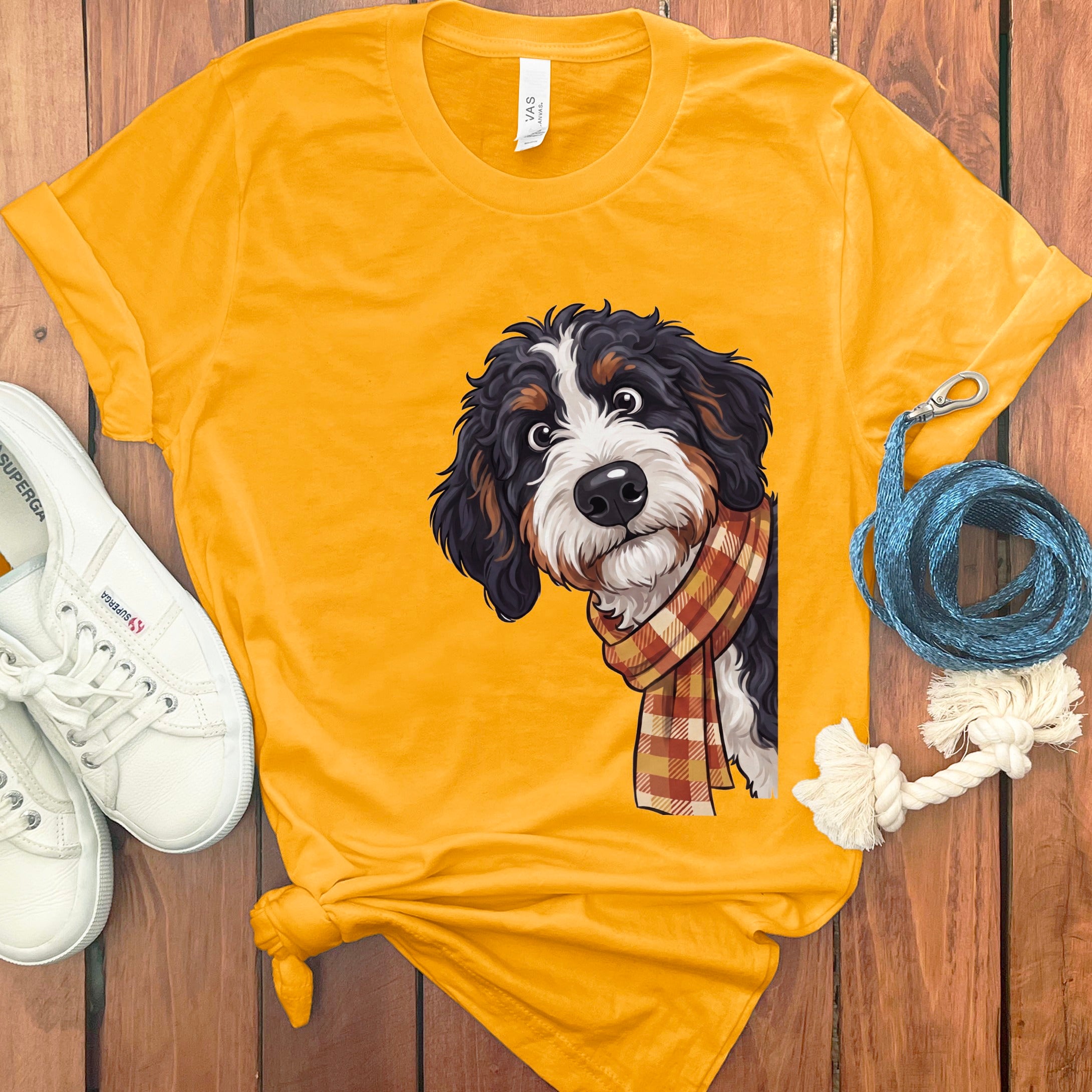 Yellow t-shirt with Bernese Mountain Dog cartoon wearing a plaid scarf.