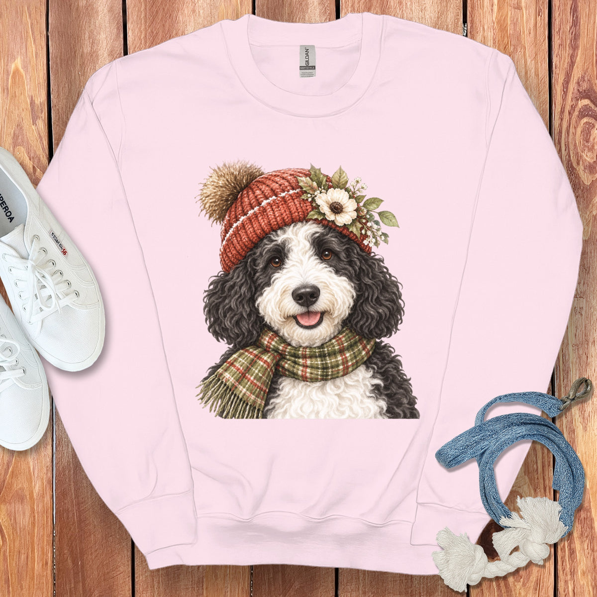 Pink crewneck sweatshirt with a drawing of a Bernedoodle wearing a beanie and scarf.