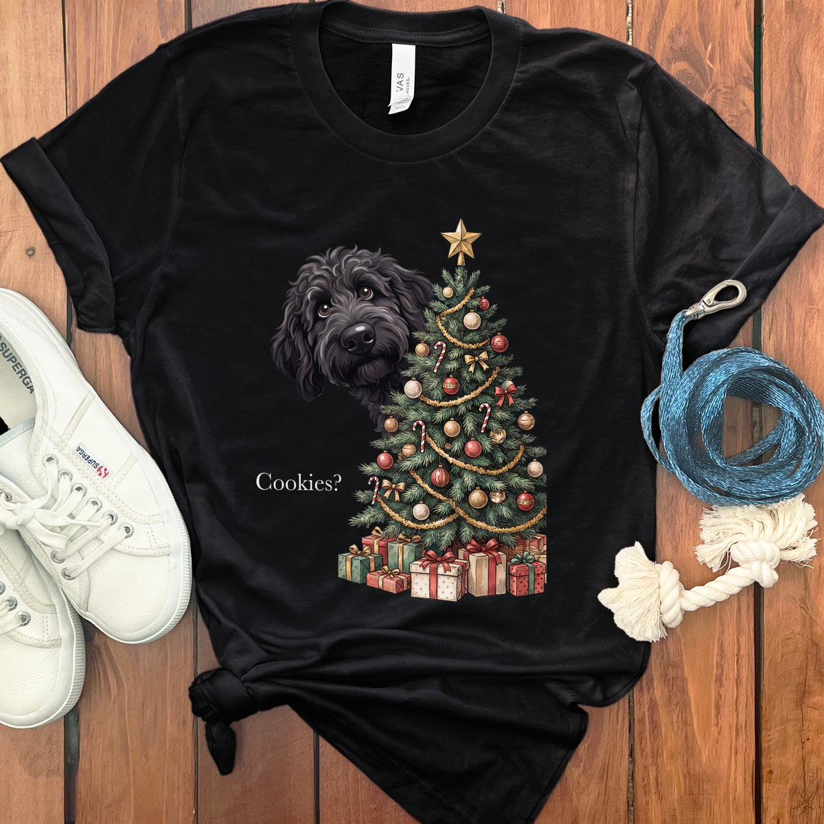 Black t-shirt with a black poodle peeking from behind a Christmas tree.