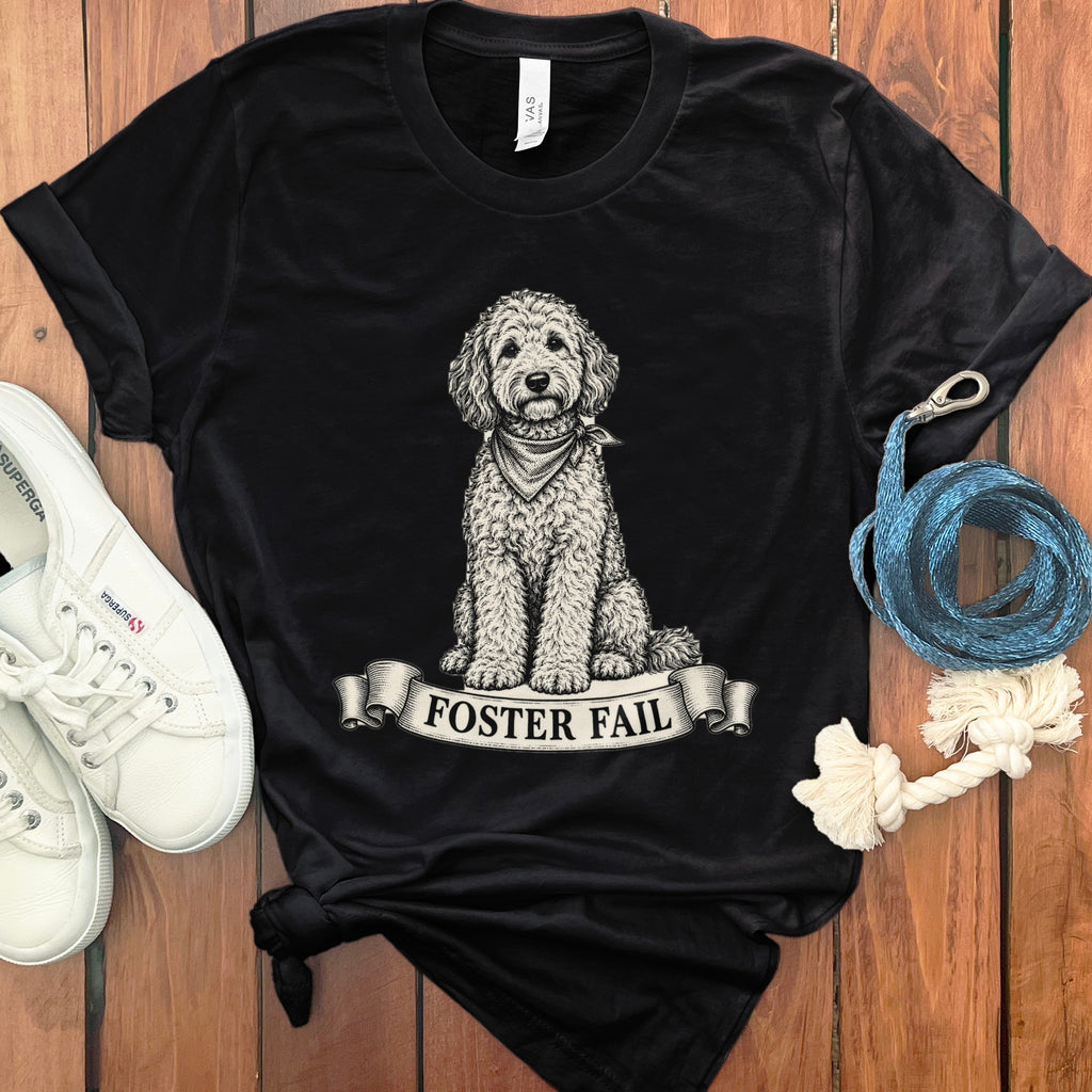 Black t-shirt with a black and white illustration of a dog wearing a bandana and the text "Foster Fail".