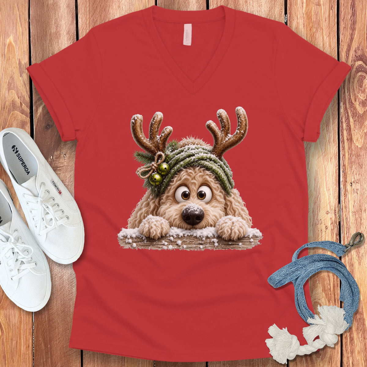 Red t-shirt with a cartoon dog wearing reindeer antlers and a green hat.