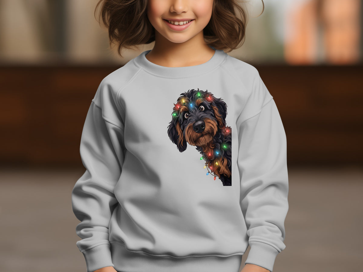 Grey sweatshirt with a dog peeking out, wearing colorful Christmas lights.