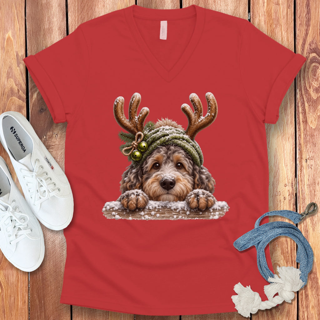 Red v-neck t-shirt with a festive dog wearing antlers and a beanie graphic.