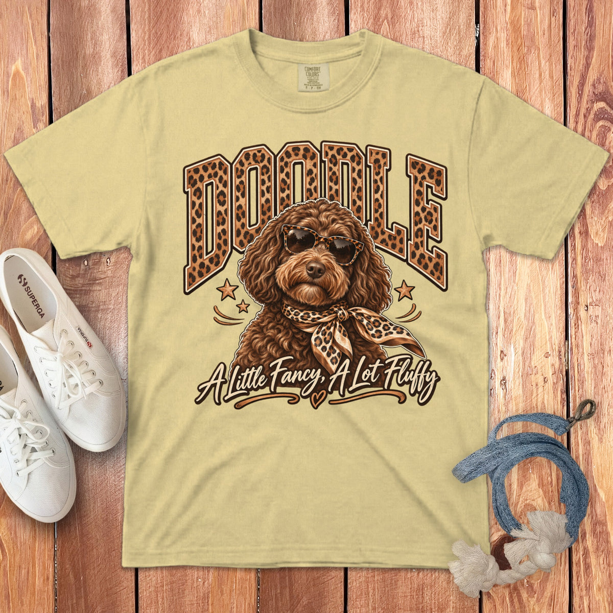 Yellow t-shirt with "DOODLE" in leopard print and a dog wearing sunglasses and scarf.