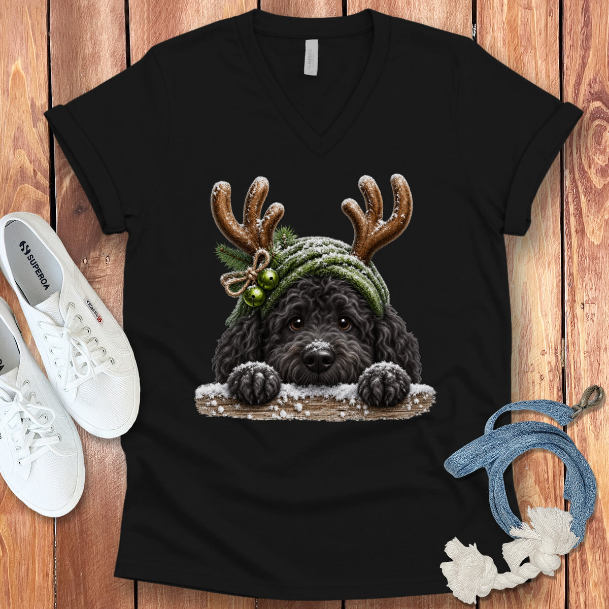Black t-shirt with a black dog wearing antlers and a green scarf with bells.