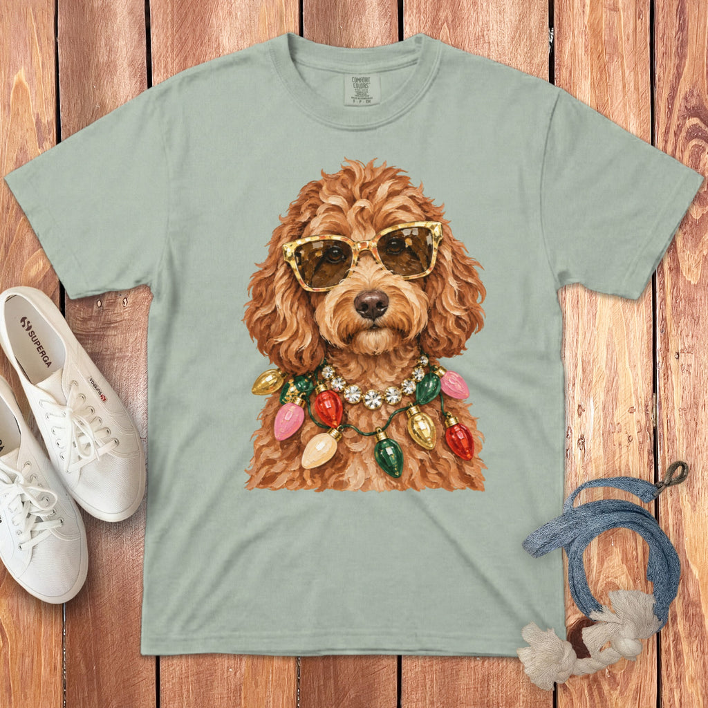 Light green t-shirt with a doodle wearing sunglasses and a Christmas light necklace.