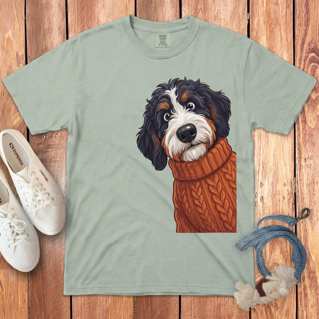 Mint green t-shirt with Bernese Mountain Dog wearing an orange sweater graphic.