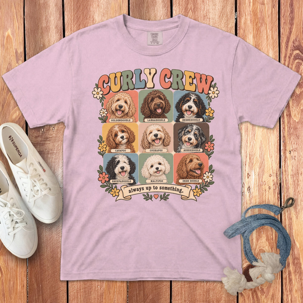 Light pink t-shirt featuring a grid of nine doodle dog breeds, labeled Curly Crew.
