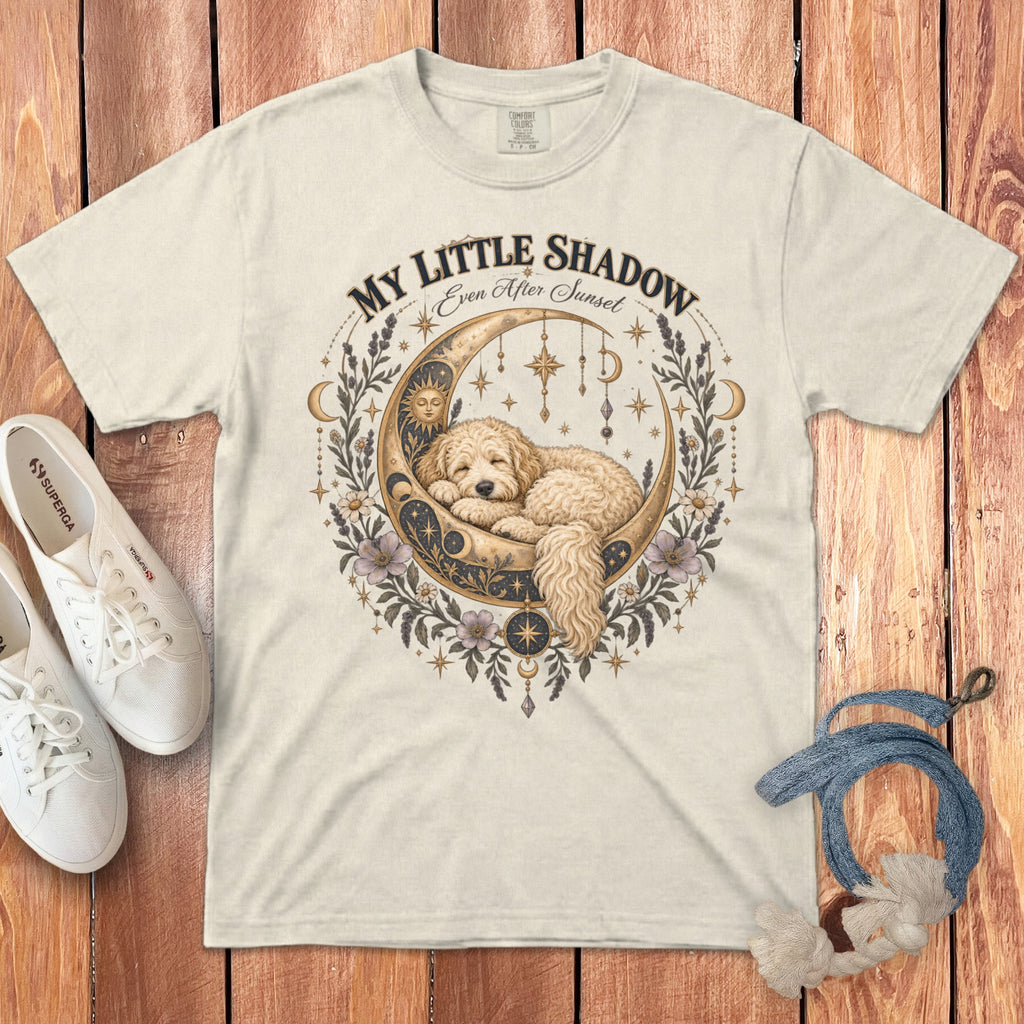Cream t-shirt with a gold moon, sleeping dog, and floral celestial design.