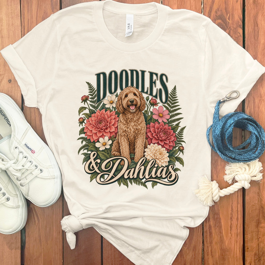 Cream t-shirt with "Doodles & Dahlias" text and a doodle dog among flowers.
