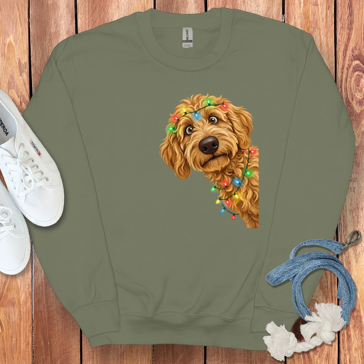 Green sweatshirt with a doodle dog wearing tangled Christmas lights.