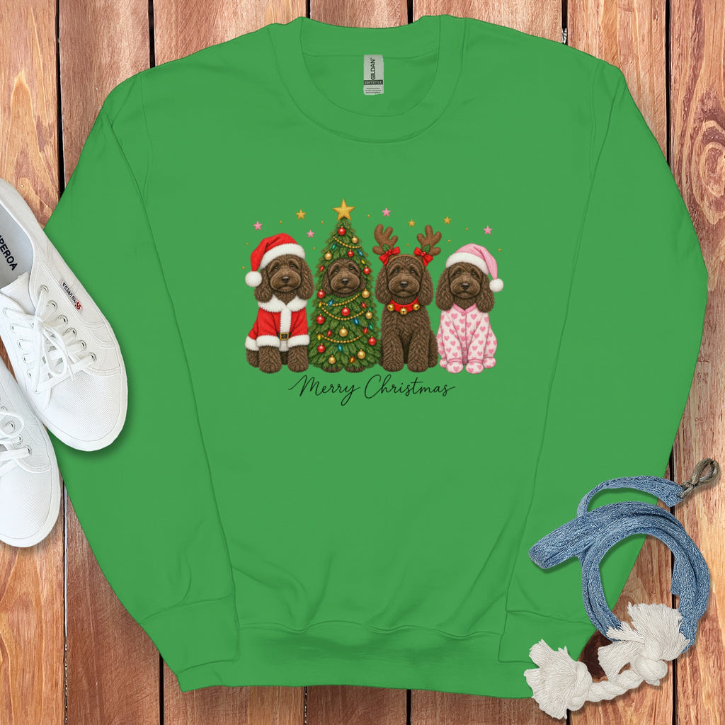 Bright green crewneck sweatshirt featuring a graphic of four brown dogs celebrating Christmas, laid on a wooden background.