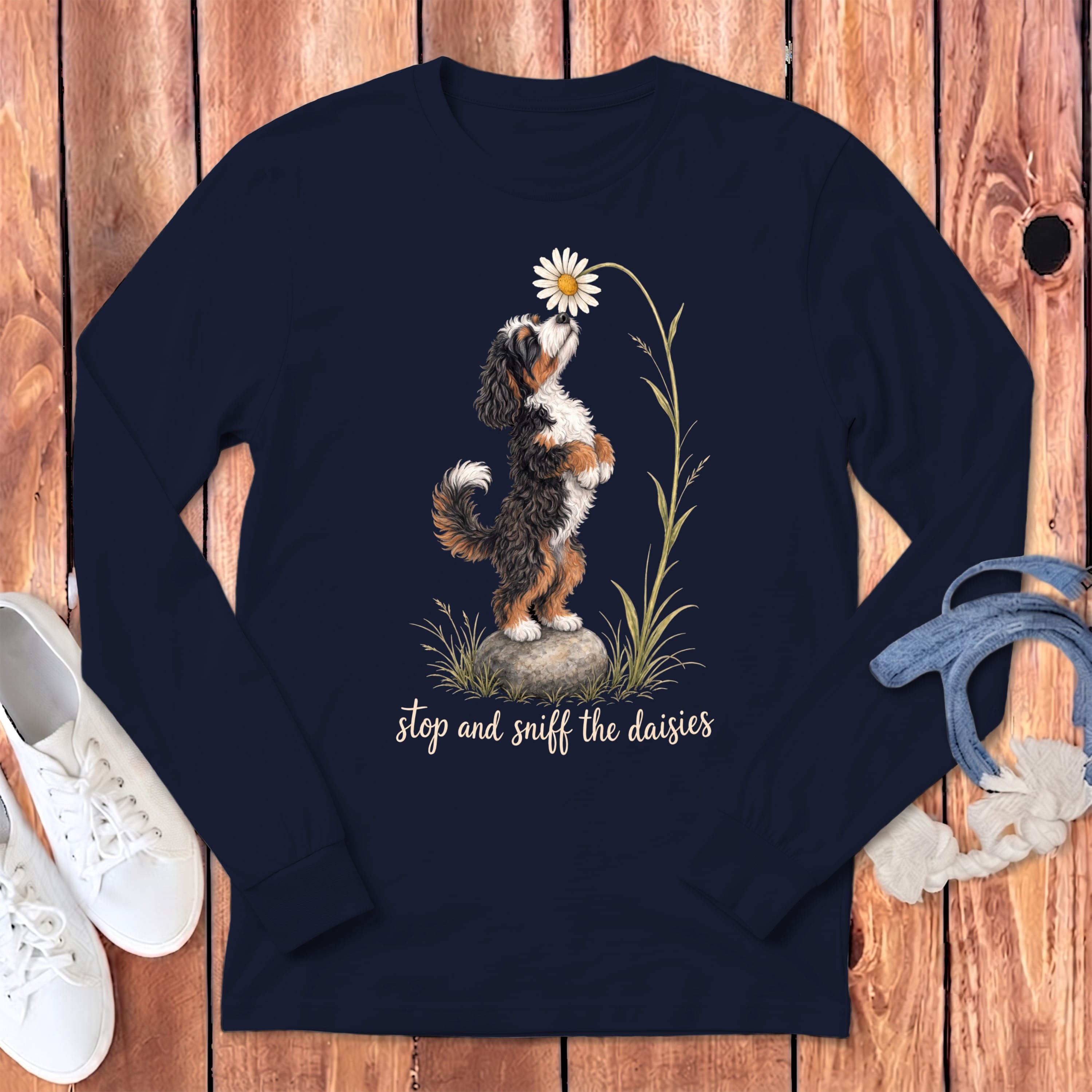Navy long-sleeve shirt with a Bernese Mountain Dog sniffing a daisy and the text "stop and sniff the daisies."