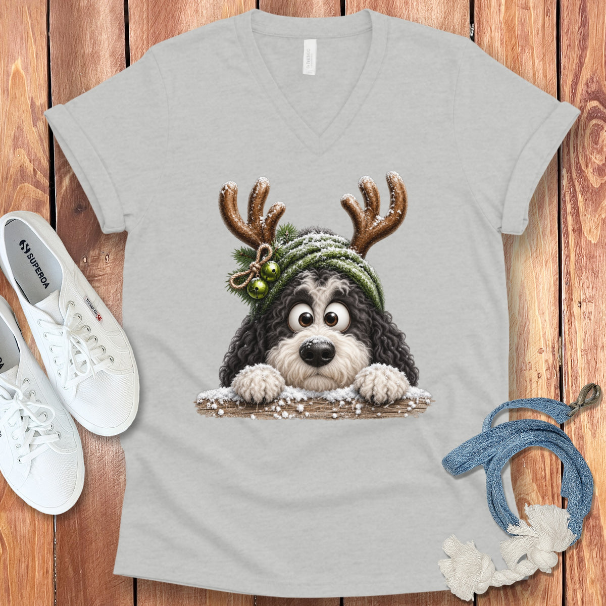 Light grey v-neck t-shirt with a cartoon dog wearing antlers and a winter hat.