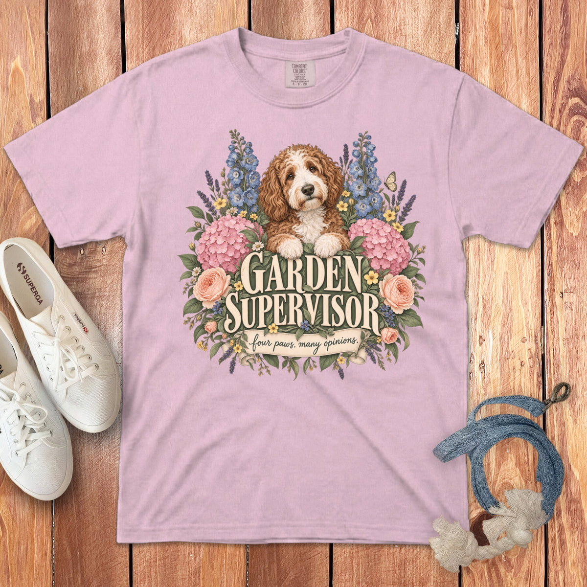 A pink t-shirt with a graphic of a labradoodle surrounded by flowers and the text Garden Supervisor.