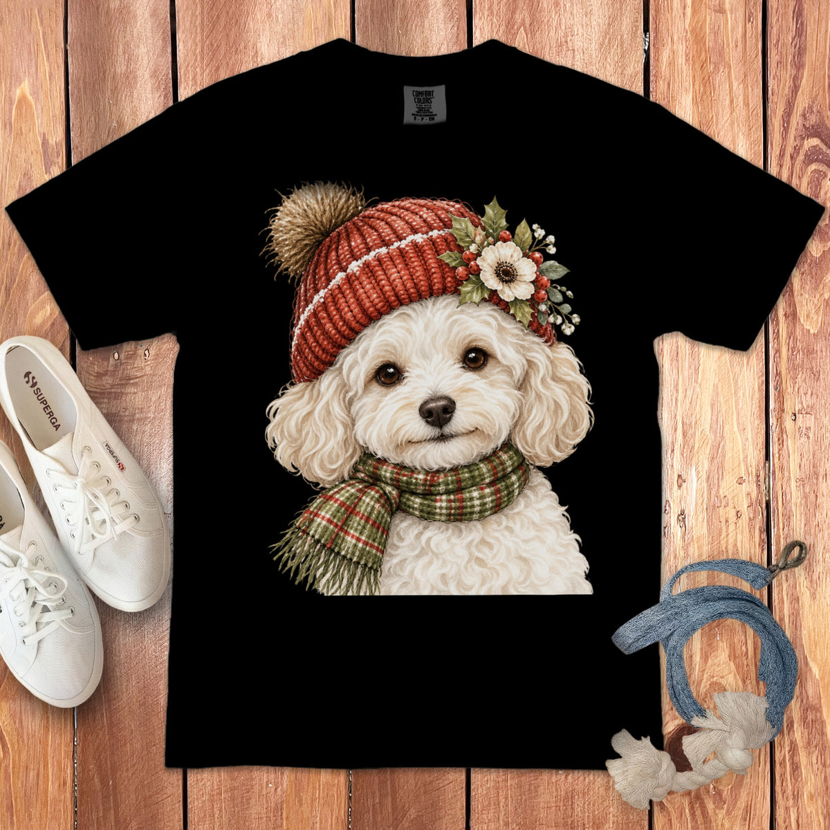 Black t-shirt with fluffy white dog wearing red hat and green scarf.