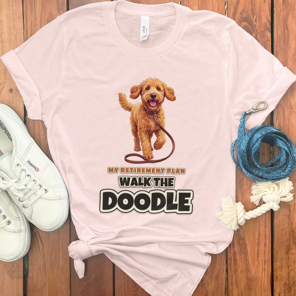 Pink t-shirt with a doodle dog graphic and text "My Retirement Plan Walk The Doodle".