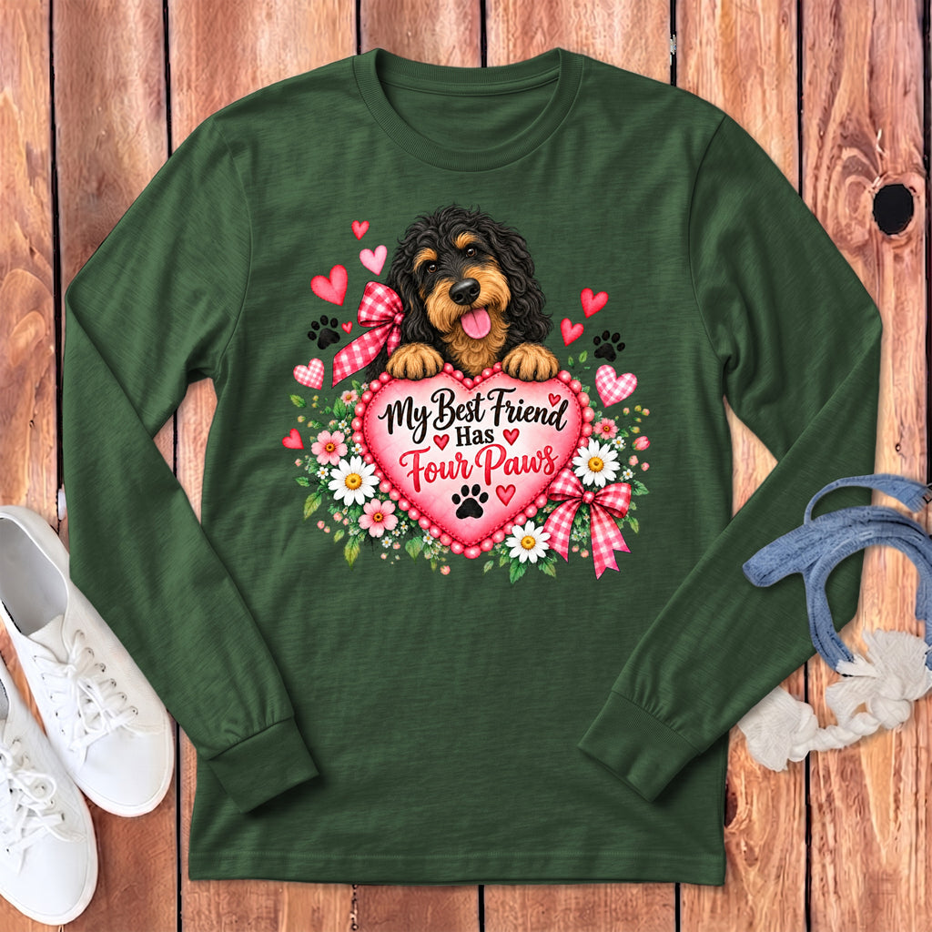 Dark green long-sleeve t-shirt featuring a black and tan dog holding a pink heart with text.