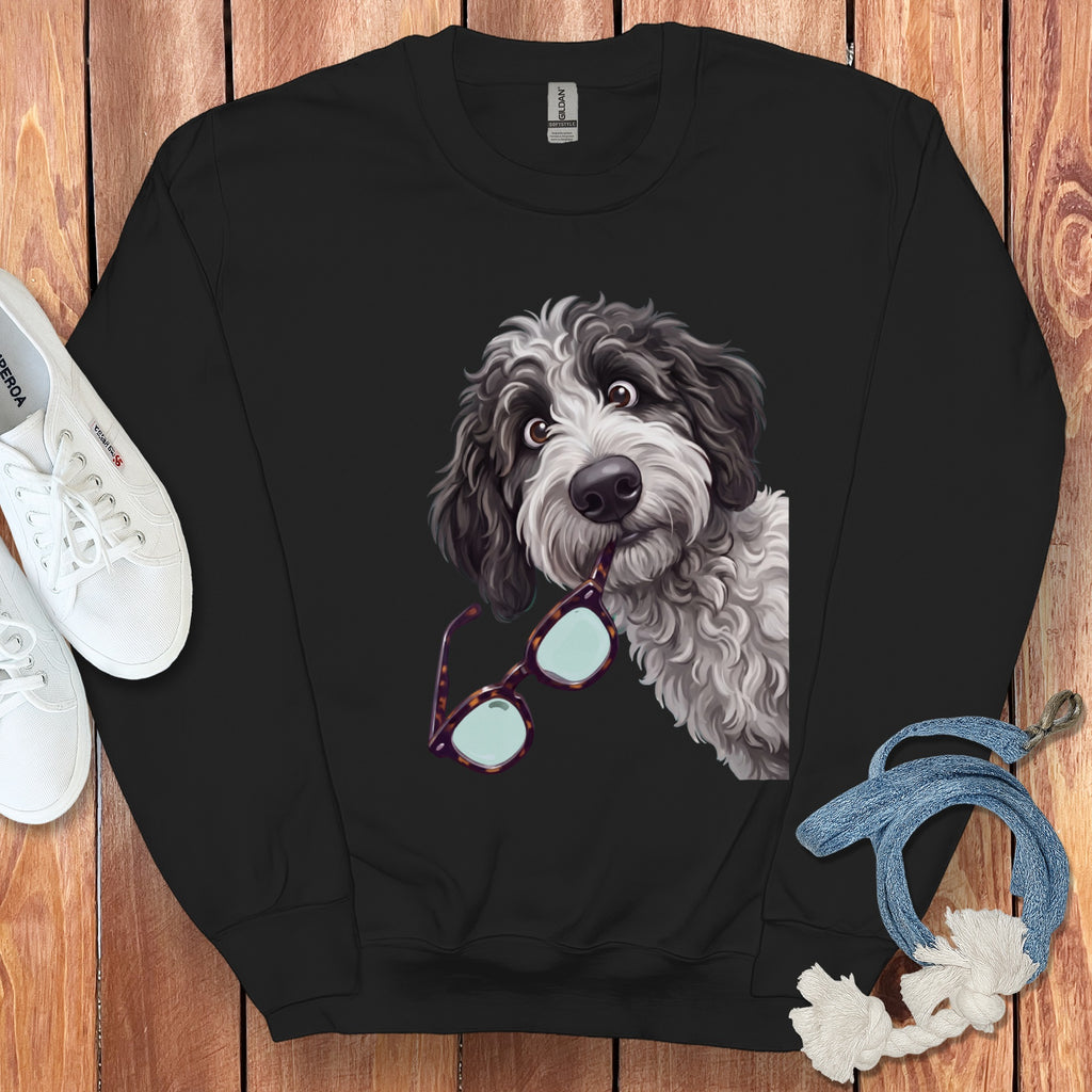 Black crewneck sweatshirt featuring a graphic of a shaggy doodle dog holding glasses in its mouth.