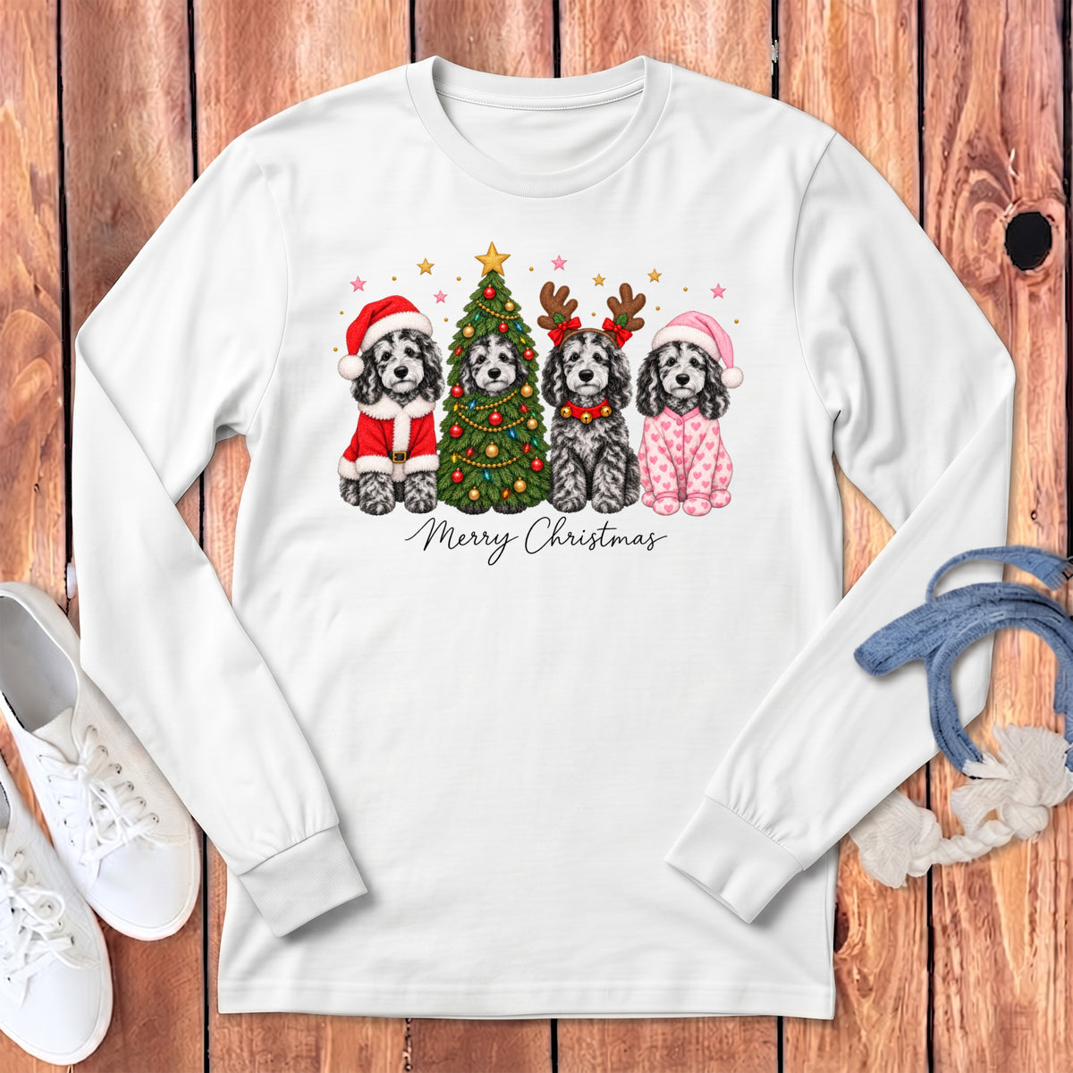 A white long-sleeved shirt featuring four illustrated dogs, a Christmas tree, and the text Merry Christmas.
