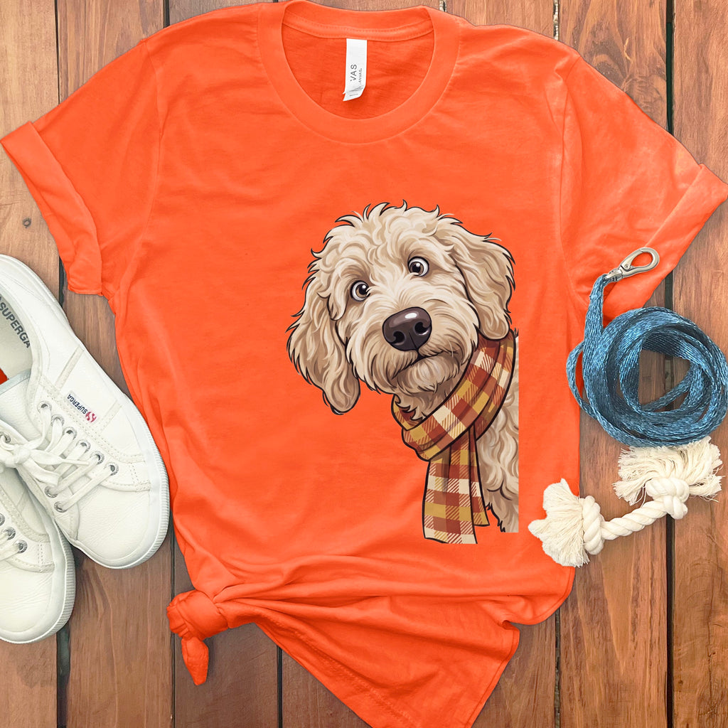 Orange t-shirt with a cartoon doodle dog wearing a plaid scarf.