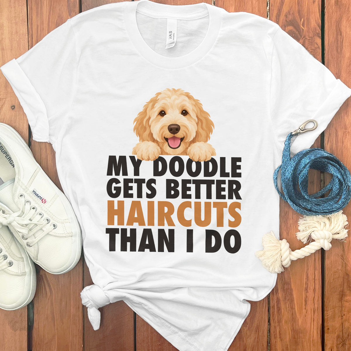 White t-shirt with a doodle dog graphic and text: "My Doodle Gets Better Haircuts Than I Do".