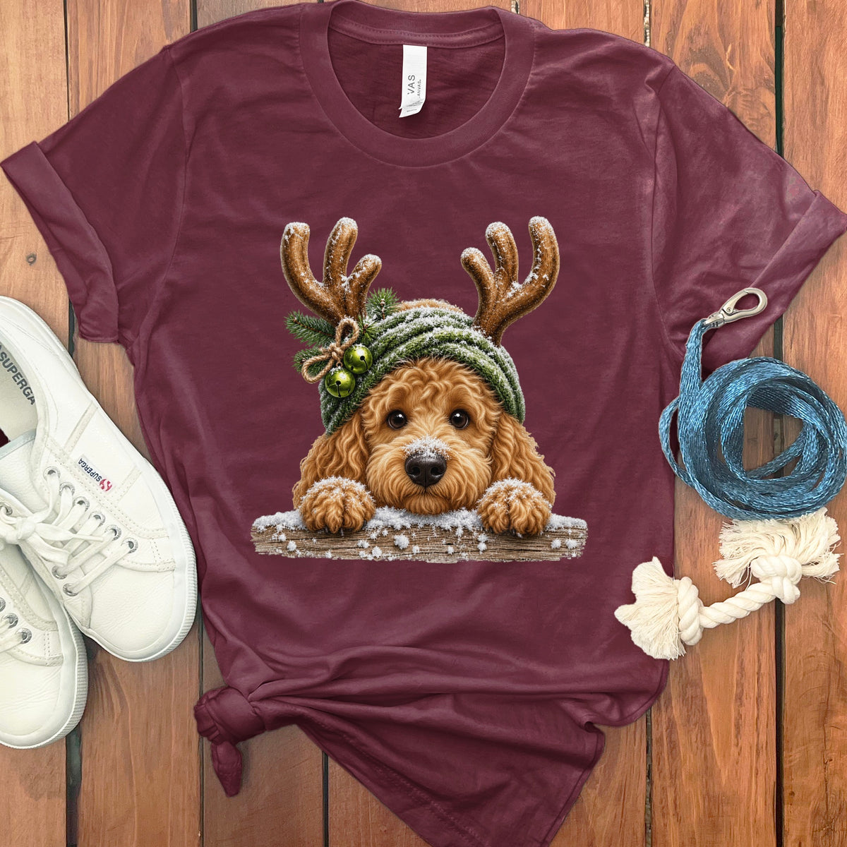 Goldendoodle dog in reindeer antlers and winter hat on a t-shirt.