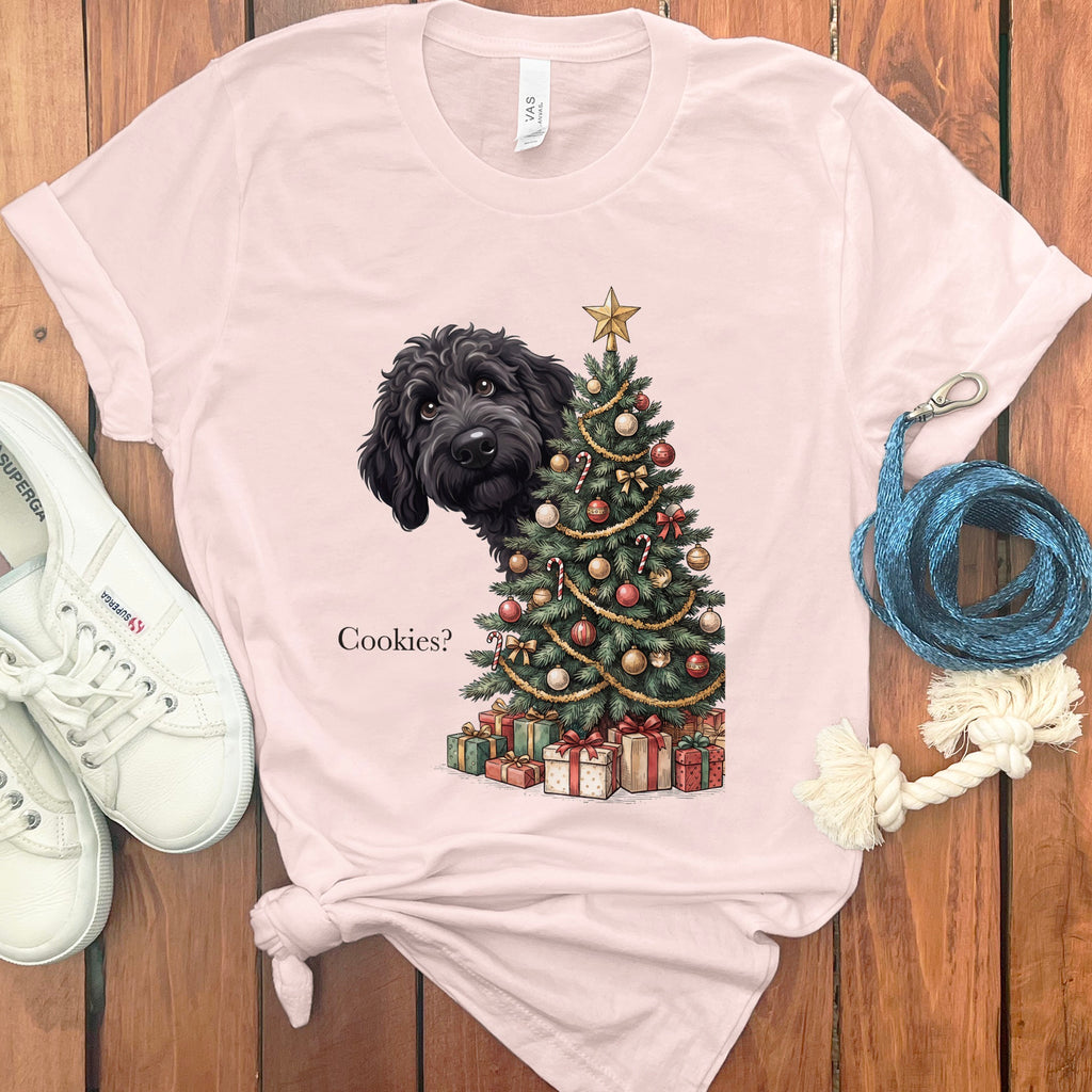 Black dog peeking behind a Christmas tree with presents and text "Cookies?".
