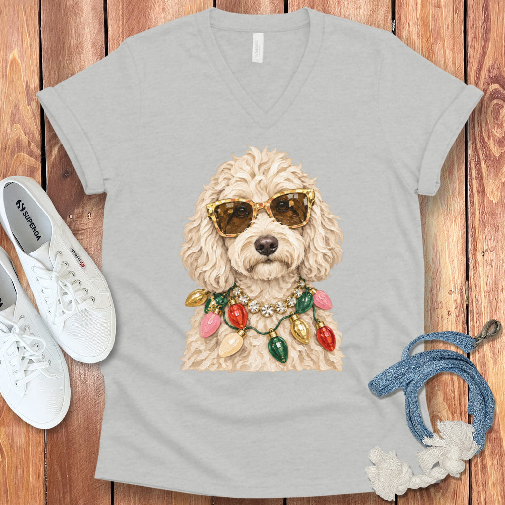 Fluffy dog wearing sunglasses and festive Christmas lights necklace.
