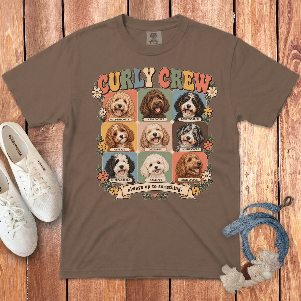 Brown crewneck t-shirt featuring a grid of nine doodle dog breeds, flowers, and the text Curly Crew.