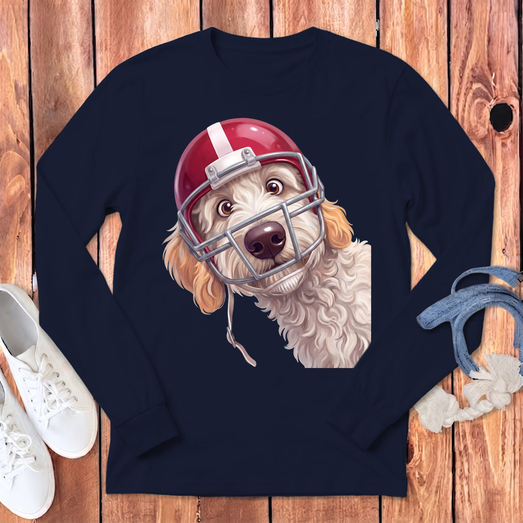 Cream doodle dog wearing a red and silver football helmet, close-up chest shot.