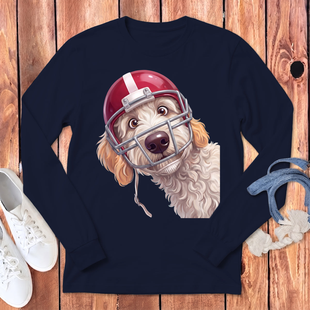 Cream doodle dog wearing a red and silver football helmet, close-up chest shot.