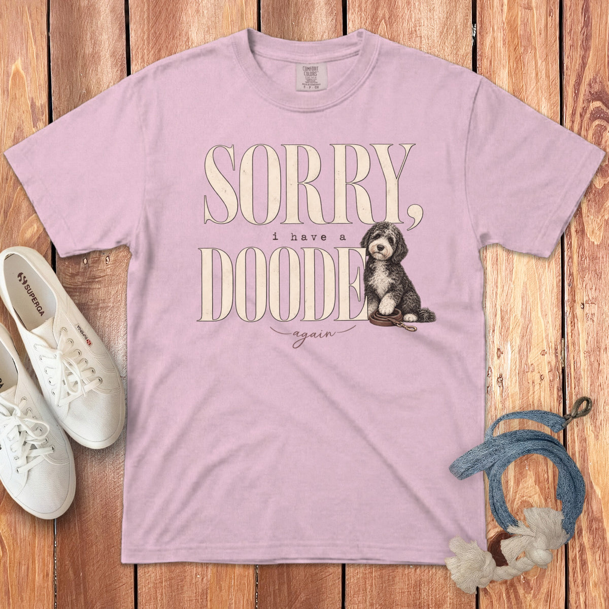 A light pink t-shirt featuring the text Sorry, I have a doodede again and a doodle puppy illustration.