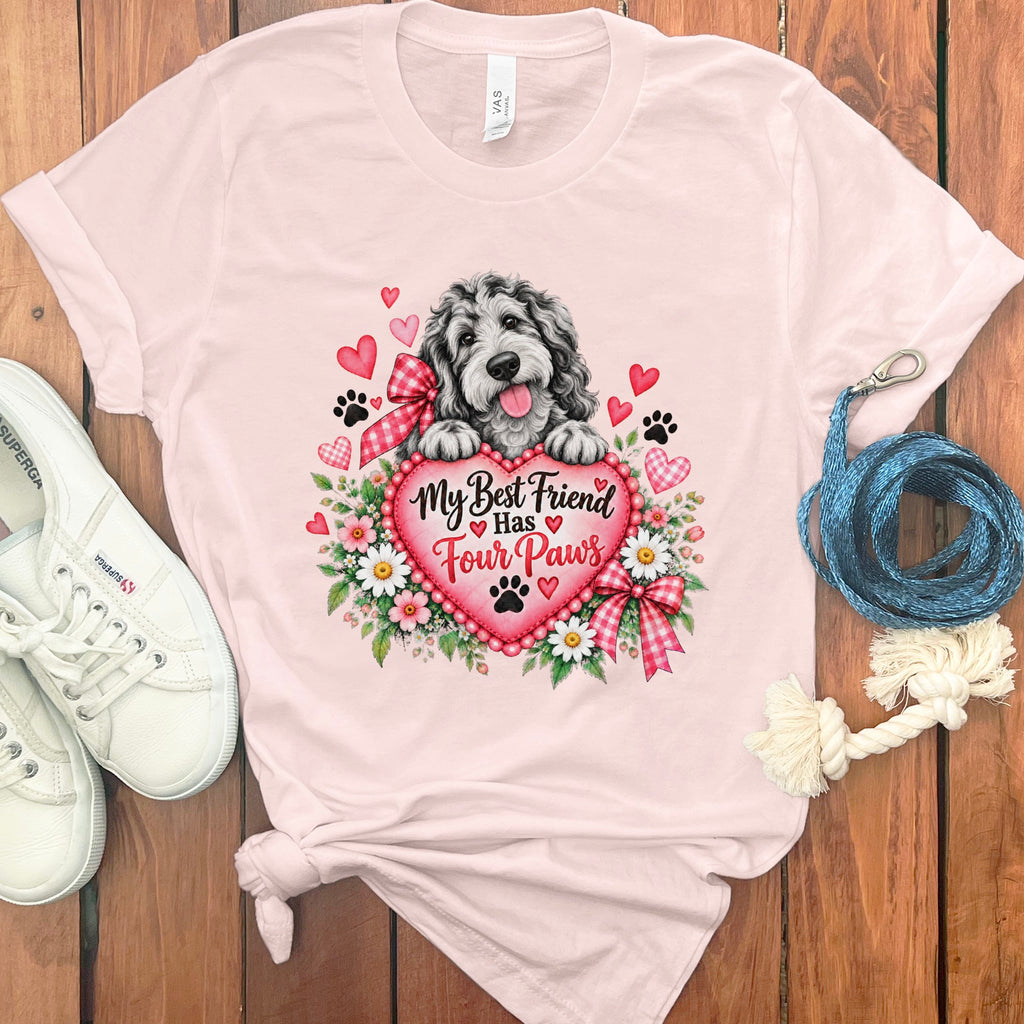 Light pink t-shirt featuring a doodle dog resting on a heart with the text My Best Friend Has Four Paws.