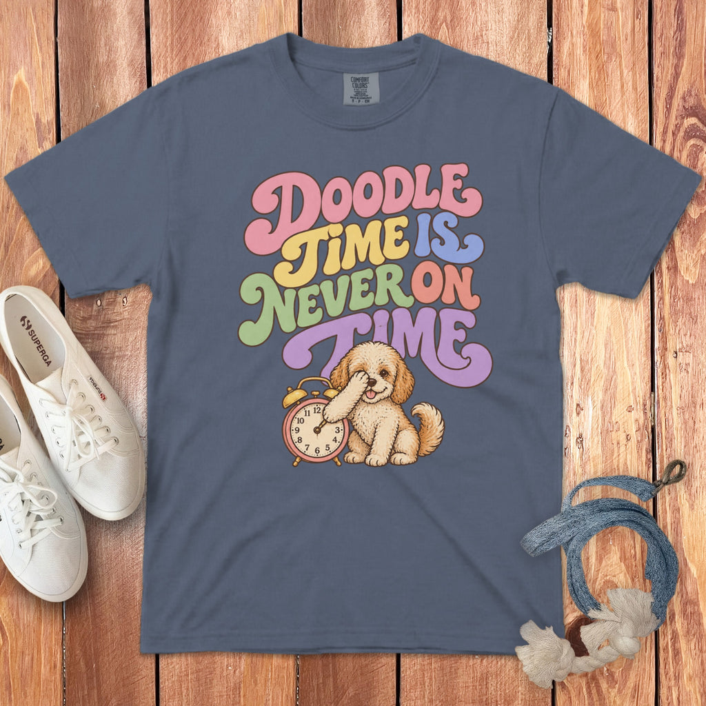 Blue t-shirt featuring the text "Doodle Time Is Never On Time" and an illustration of a doodle puppy covering its eyes next to an alarm clock.