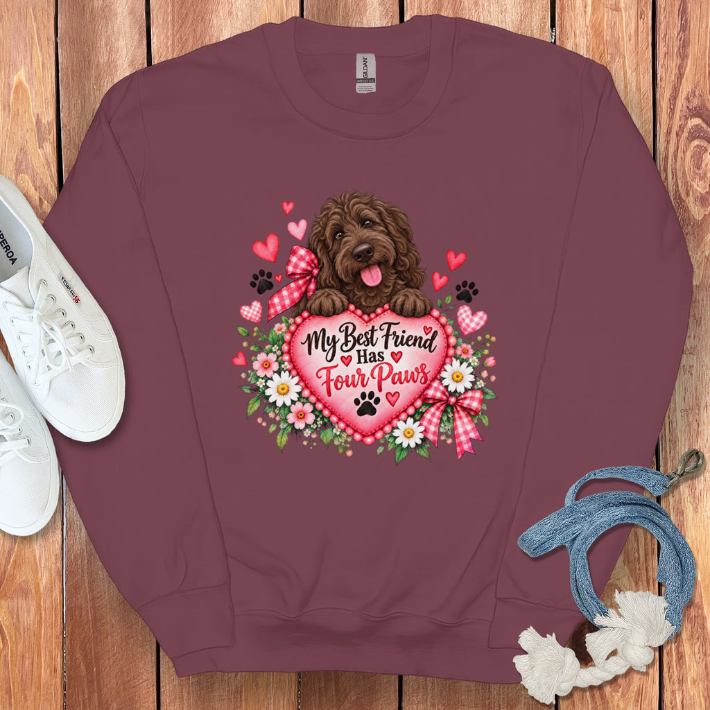 A maroon crewneck sweatshirt with a graphic of a brown dog, flowers, and the text My Best Friend Has Four Paws.