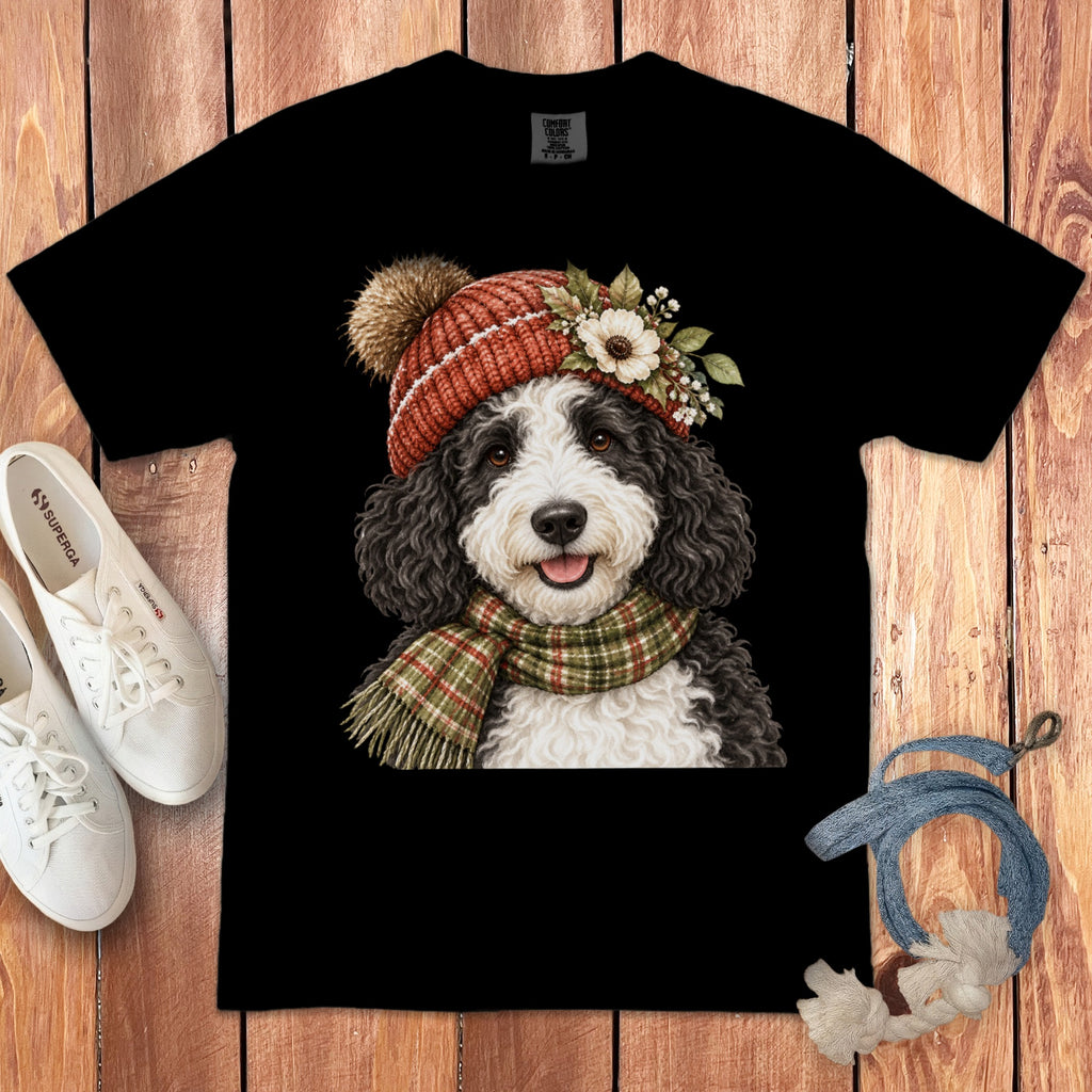 Black t-shirt with a Bernese Mountain Dog wearing a knit hat and plaid scarf.